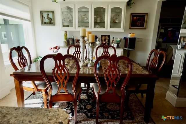 a kitchen with stainless steel appliances a sink a stove a refrigerator and cabinets