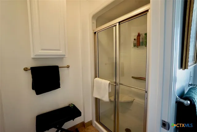 a bedroom with bed and wooden floor