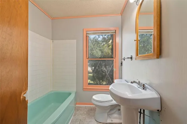 a bathroom with a sink toilet and tub