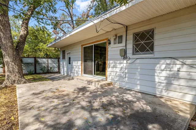 a view of a brick house with a large tree
