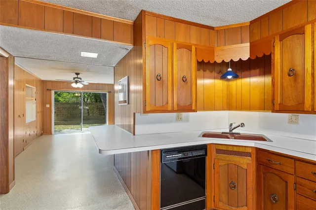 a kitchen with a sink and a large mirror