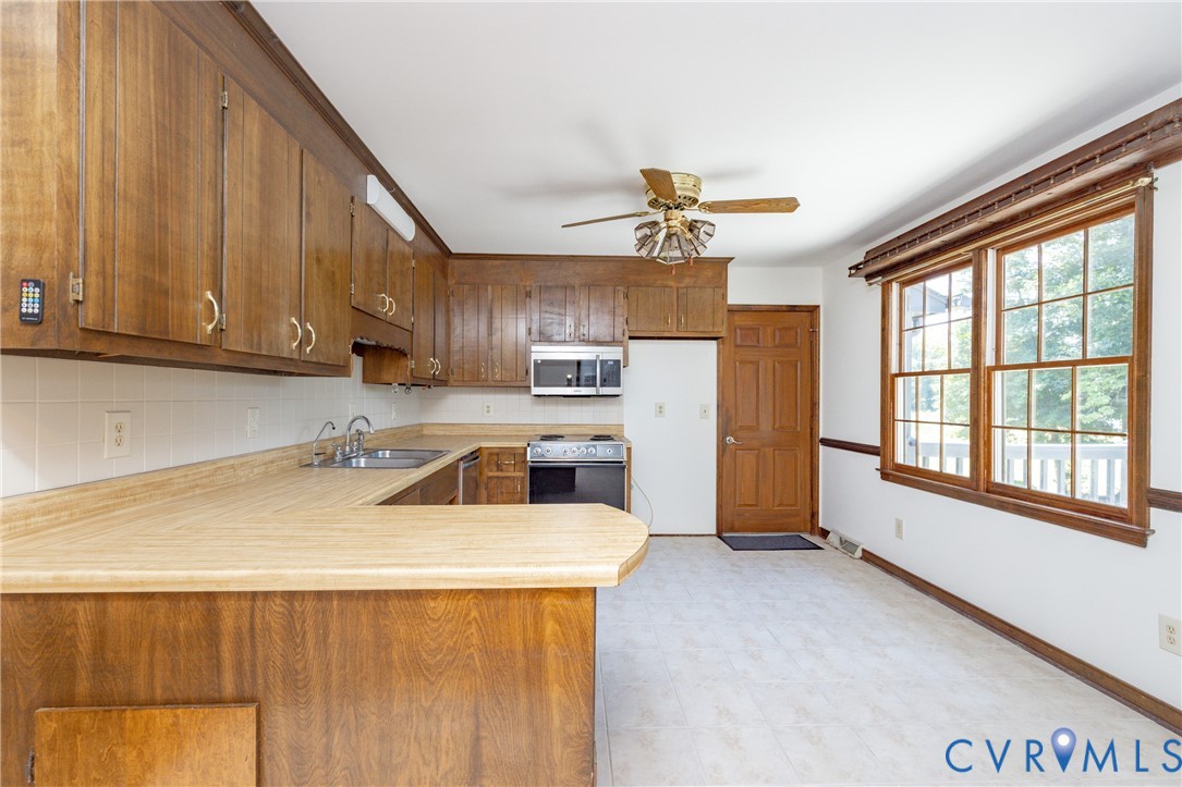 617 Rebel Ridge Road Colonial Heights, VA 23834 - Photo 17 of 49 a view of a kitchen with a sink cabinets and a window