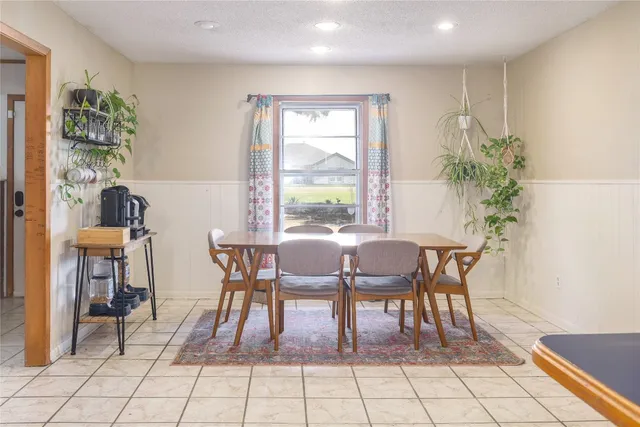 a dining room filled with furniture and window