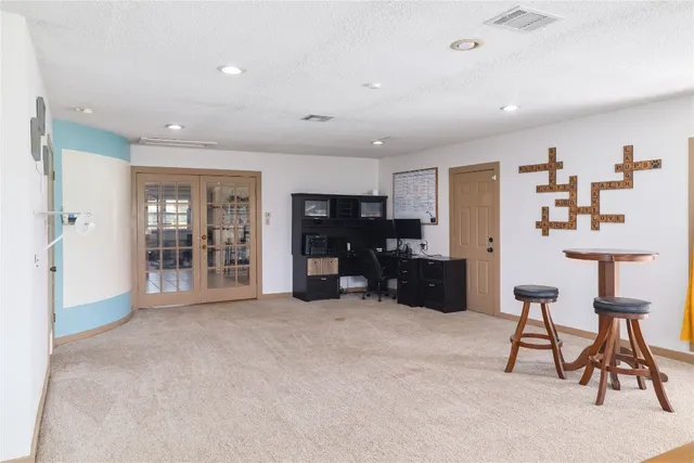 a view of an empty room with furniture and closet