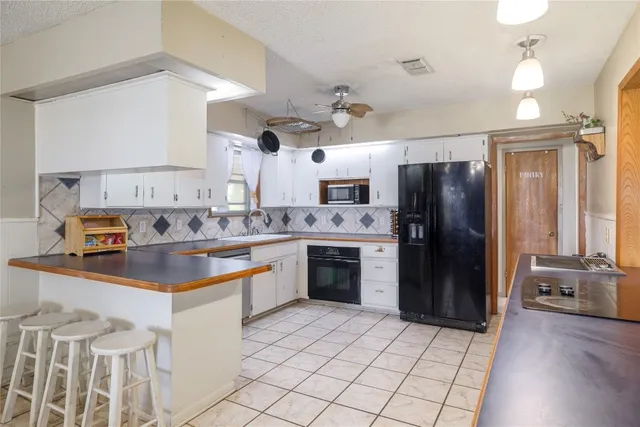 a kitchen with refrigerator cabinets and wooden floor