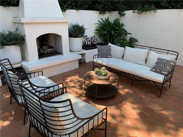 a living room with furniture a fireplace and rug