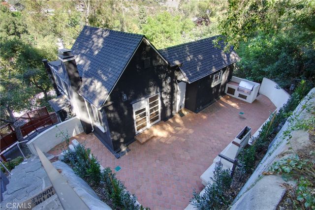 an aerial view of house with yard and mountain view in back