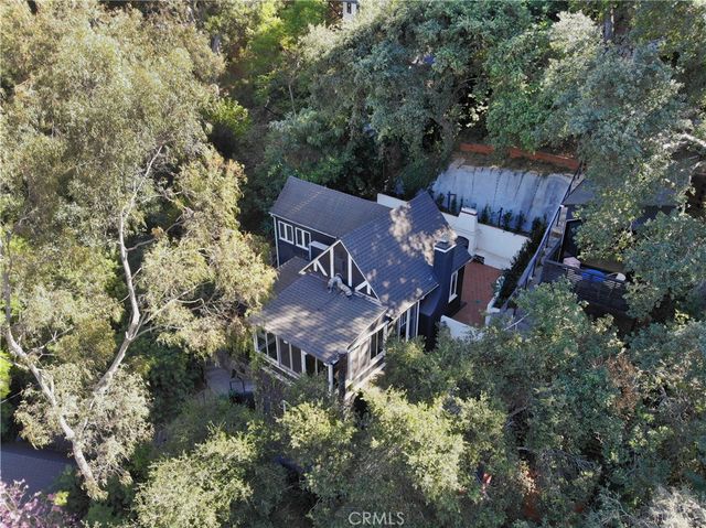 an aerial view of a house with yard and outdoor seating