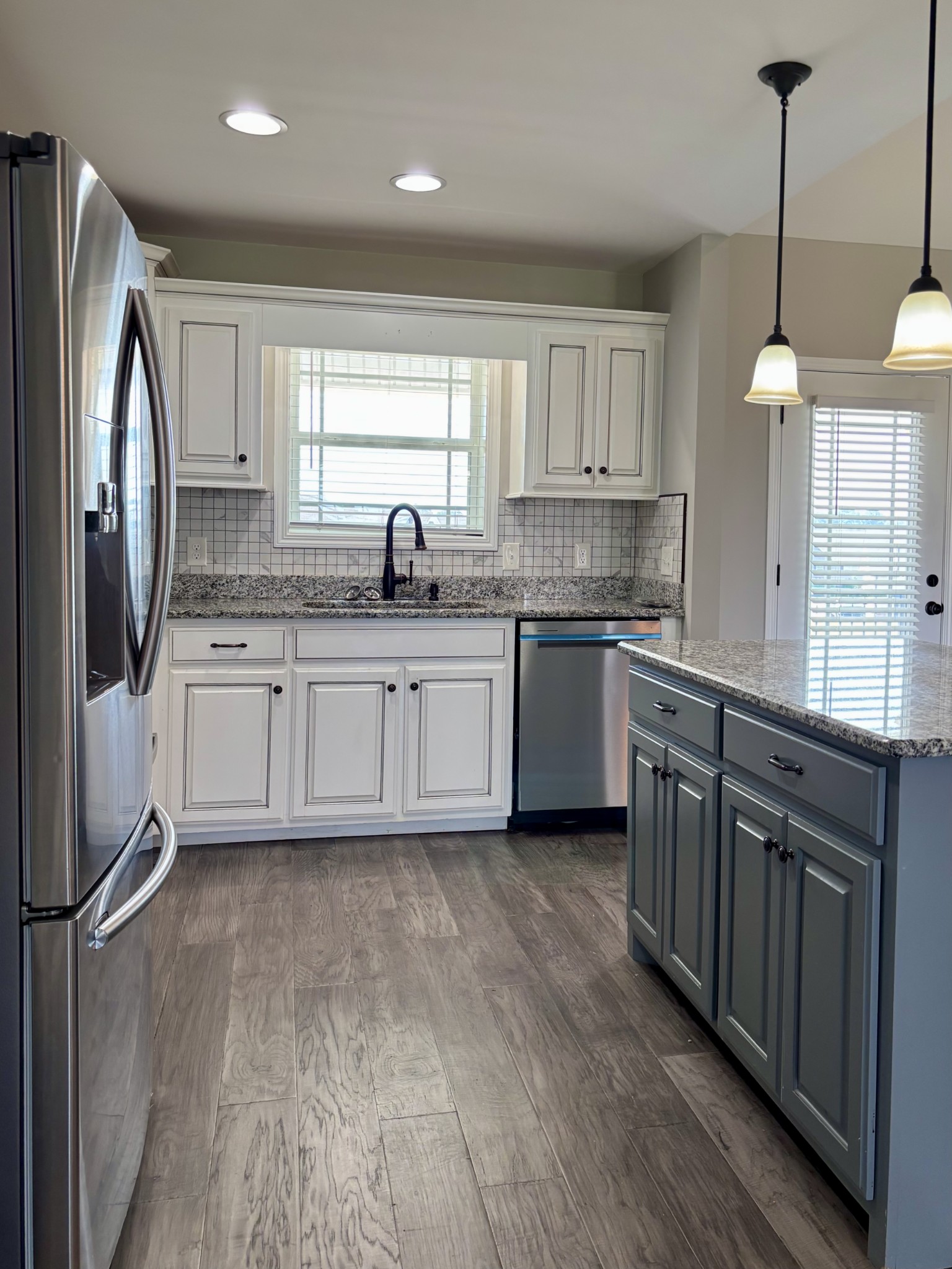 51 Regency Place Manchester, TN 37355 - Photo 6 of 27 a kitchen with stainless steel appliances granite countertop a sink a stove a refrigerator and island with wooden floor