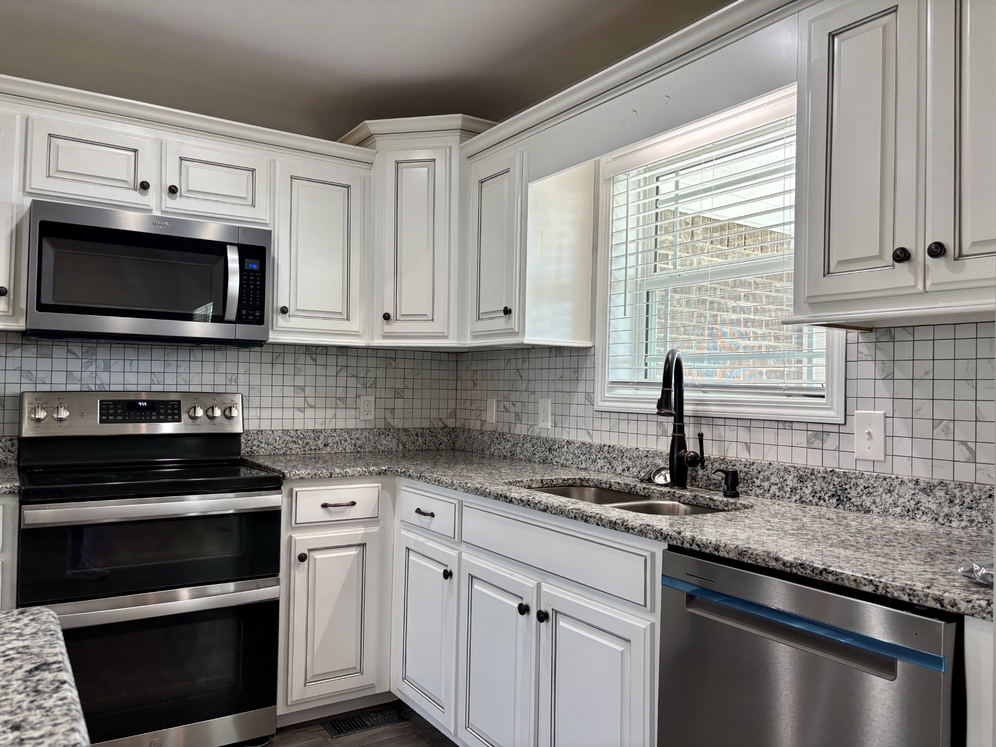 51 Regency Place Manchester, TN 37355 - Photo 8 of 27 a kitchen with granite countertop a sink cabinets and stainless steel appliances