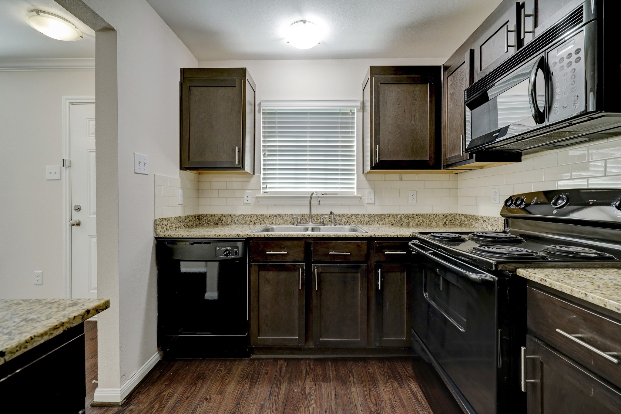 a kitchen with stainless steel appliances granite countertop a stove and a sink