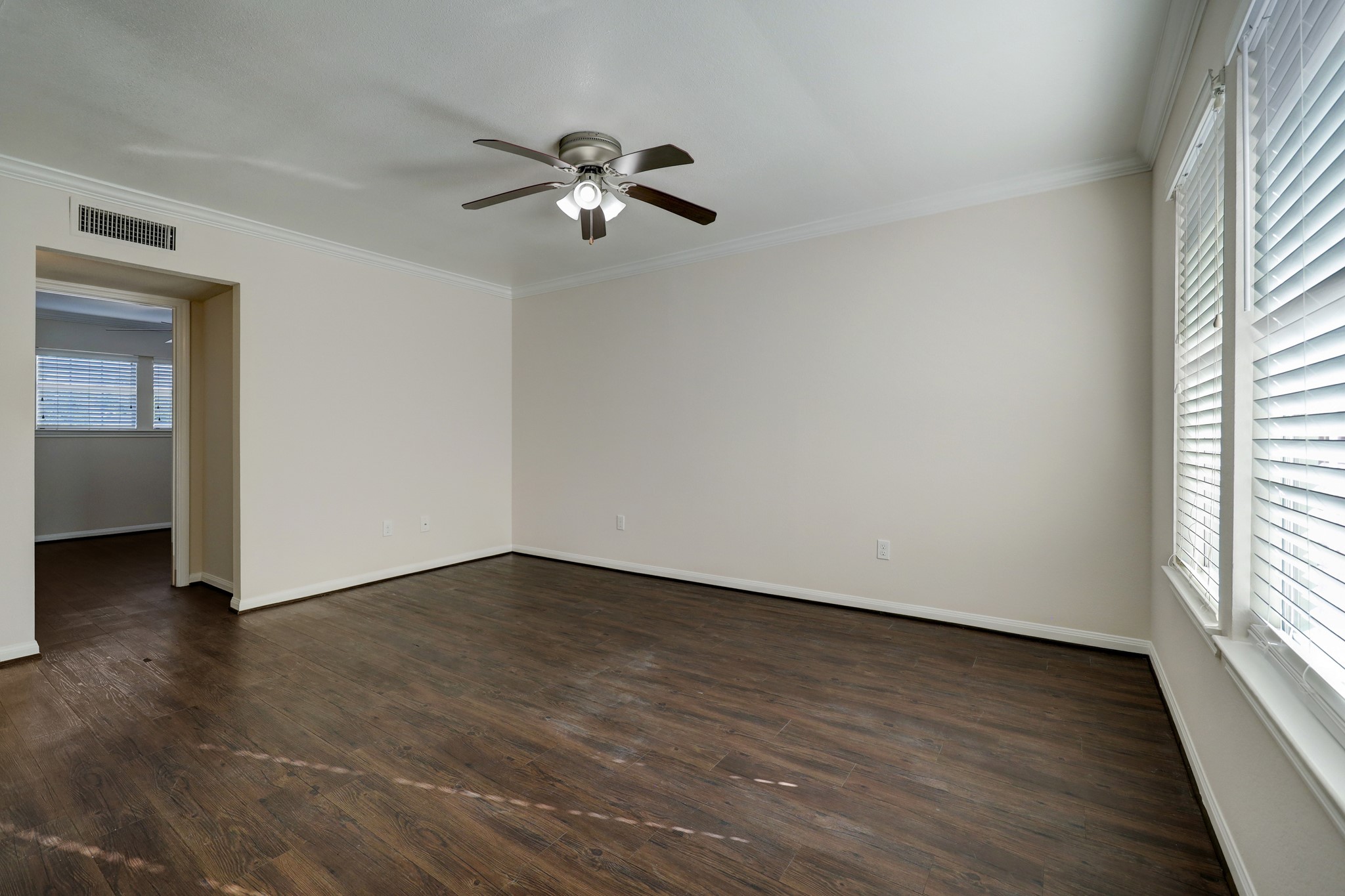 214 West 17th Street, Unit 14 Houston, TX 77008 - Photo 3 of 8 a view of an empty room with wooden floor and a window