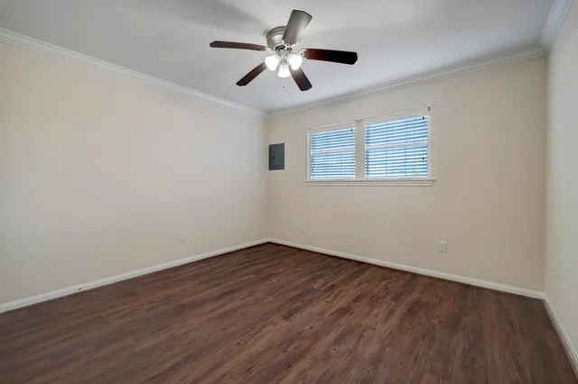 a view of empty room with wooden floor