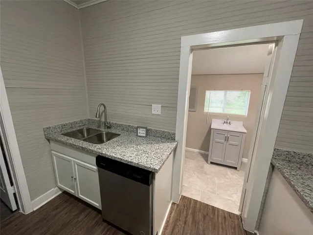 a kitchen with a sink stove and cabinets