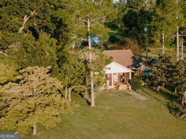 a view of a house with a tree in the background