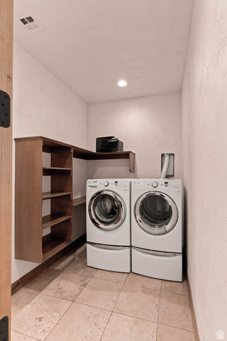 2464 East Granite Way St. George, UT 84790 - Photo 78 of 106 Laundry room (west wing of house) featuring a textured wall, washing machine and dryer, and light tile patterned floors