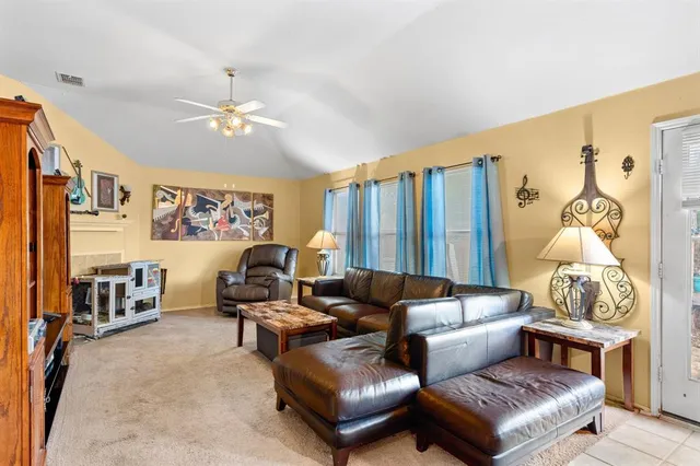 a living room with furniture ceiling fan and a rug