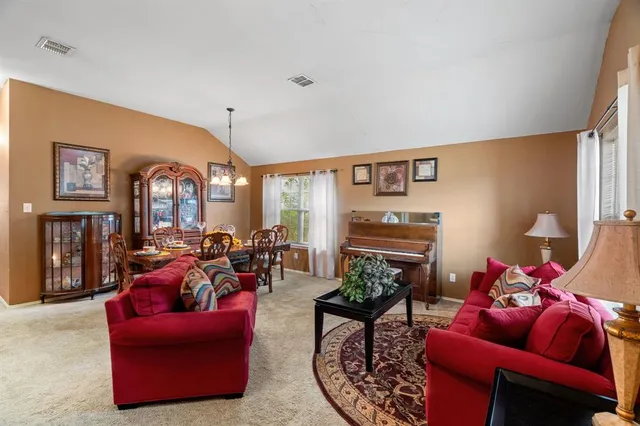 a living room with furniture a rug and a chandelier