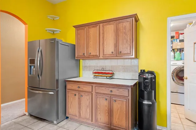 a kitchen with stainless steel appliances granite countertop a refrigerator and a stove