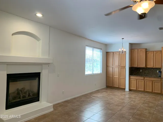 an empty room with windows and fireplace