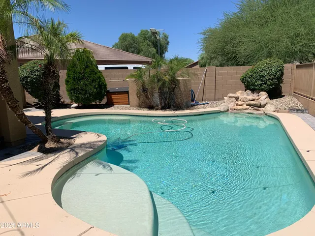 a view of backyard with swimming pool
