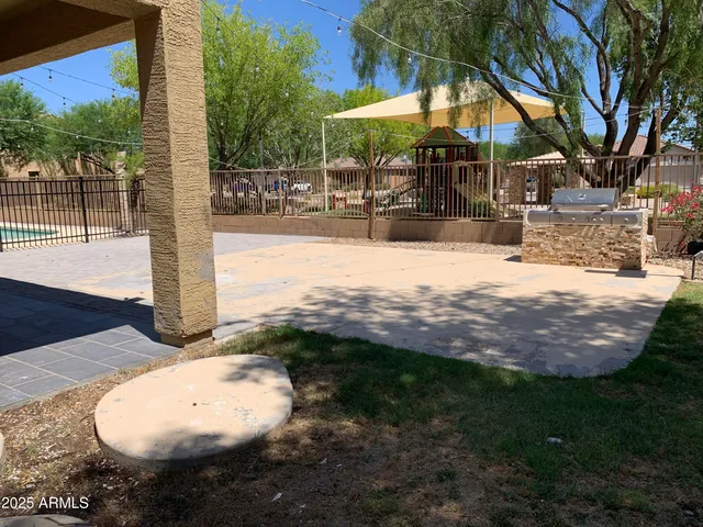 a view of a backyard with potted plants and large tree