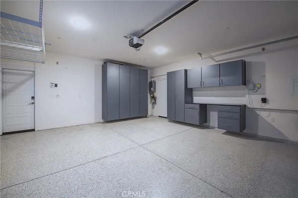 a view of a kitchen with a sink and refrigerator