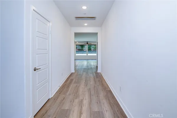 a view of a hallway with wooden floor