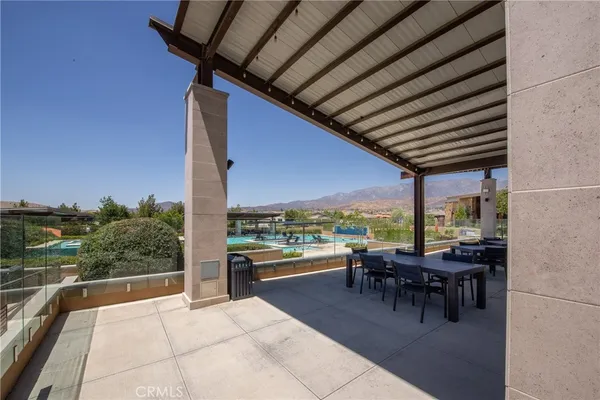 a view of a patio with a dining table and chairs with wooden floor