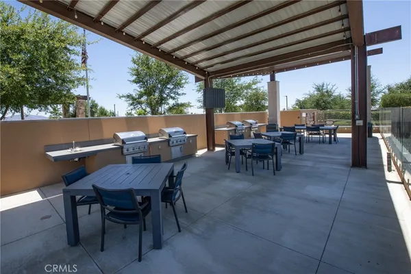 a view of a dining table and chairs in the patio