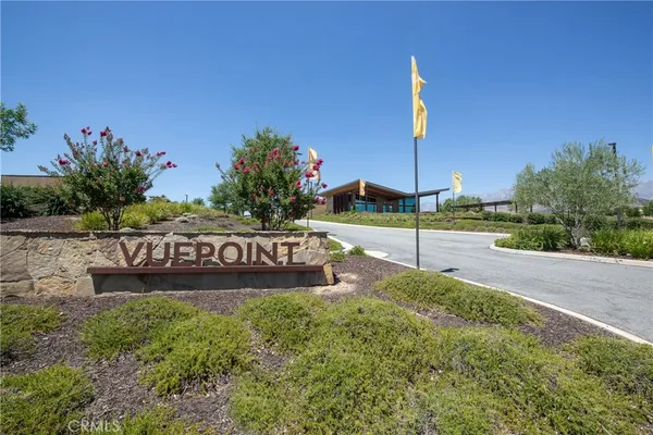 a view of a street with a building and a street sign