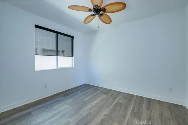a view of a room with wooden floor and fan