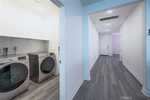 a view of a hallway with washer and dryer