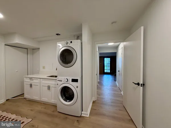 a view of a hallway with washer and dryer
