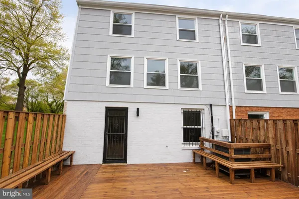 a backyard of a house with barbeque oven and outdoor seating