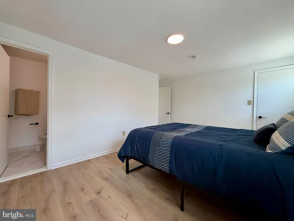 a bedroom with a bed and a night stand
