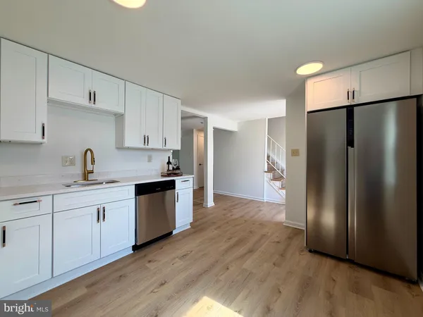 a kitchen with a refrigerator and a sink