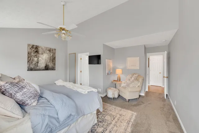 a spacious bedroom with a bed and window