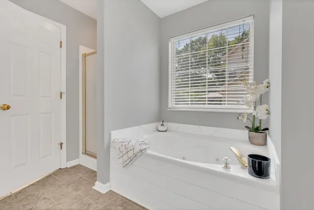 a bathroom with a bathtub and a window