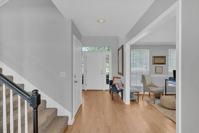 a view of a livingroom with furniture and hardwood floor