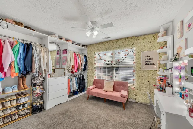 a bedroom with furniture and a flat screen tv