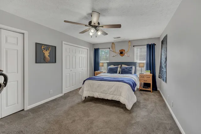 a bedroom with a large bed and a chandelier