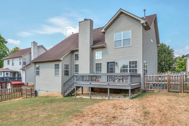 a view of a house with wooden fence
