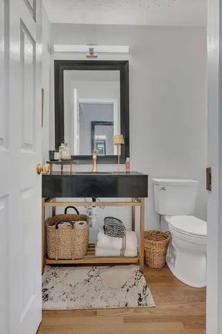 a bathroom with a toilet a sink and mirror