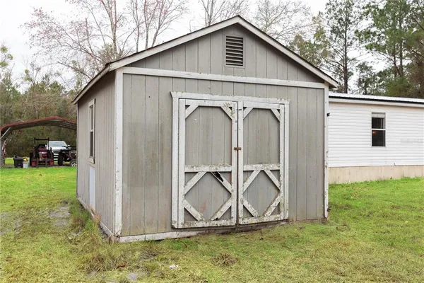 a view of a car park in front of a house