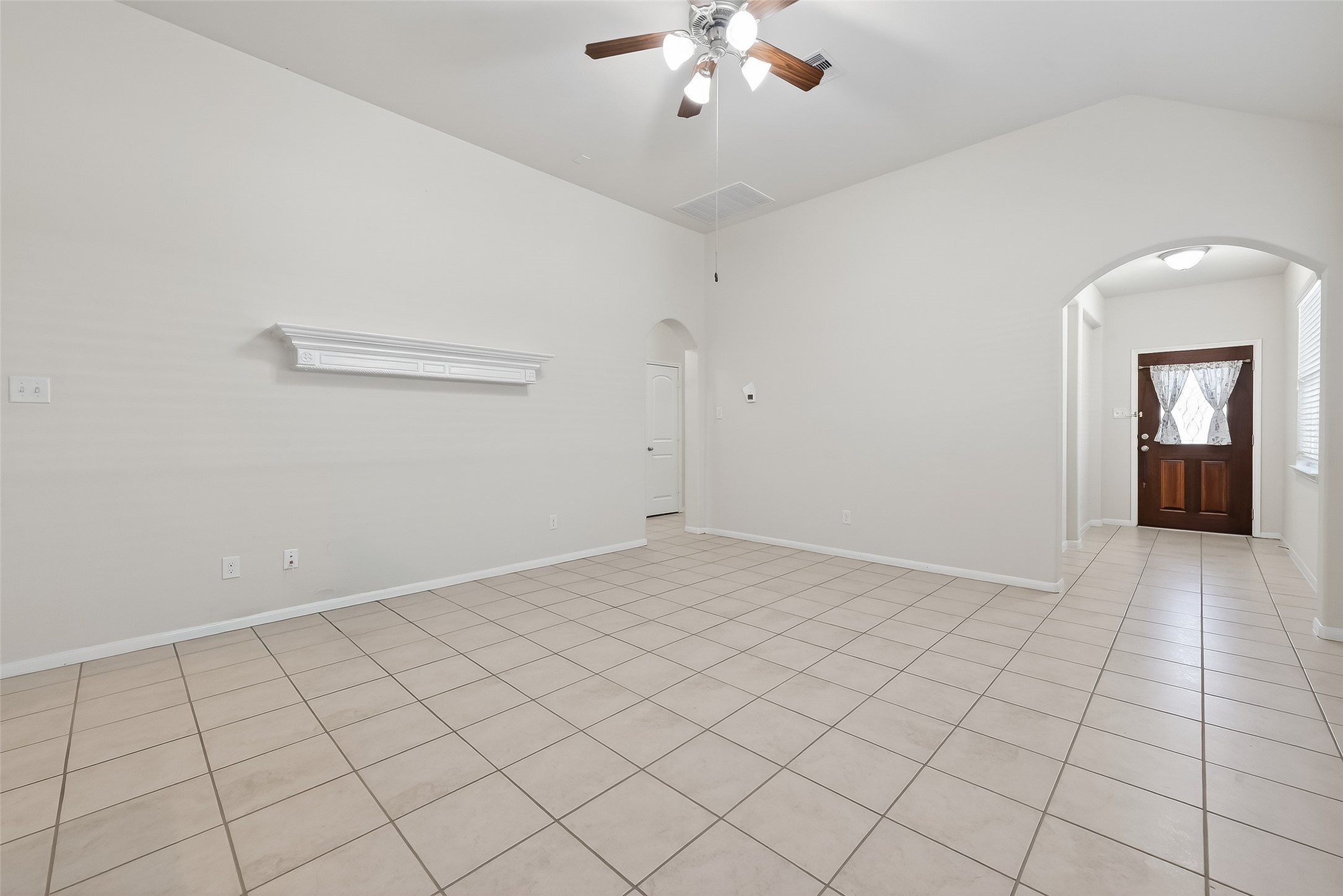 7631 Granite Terrace Lane Houston, TX 77083 - Photo 9 of 46 a view of an empty room with a chandelier fan