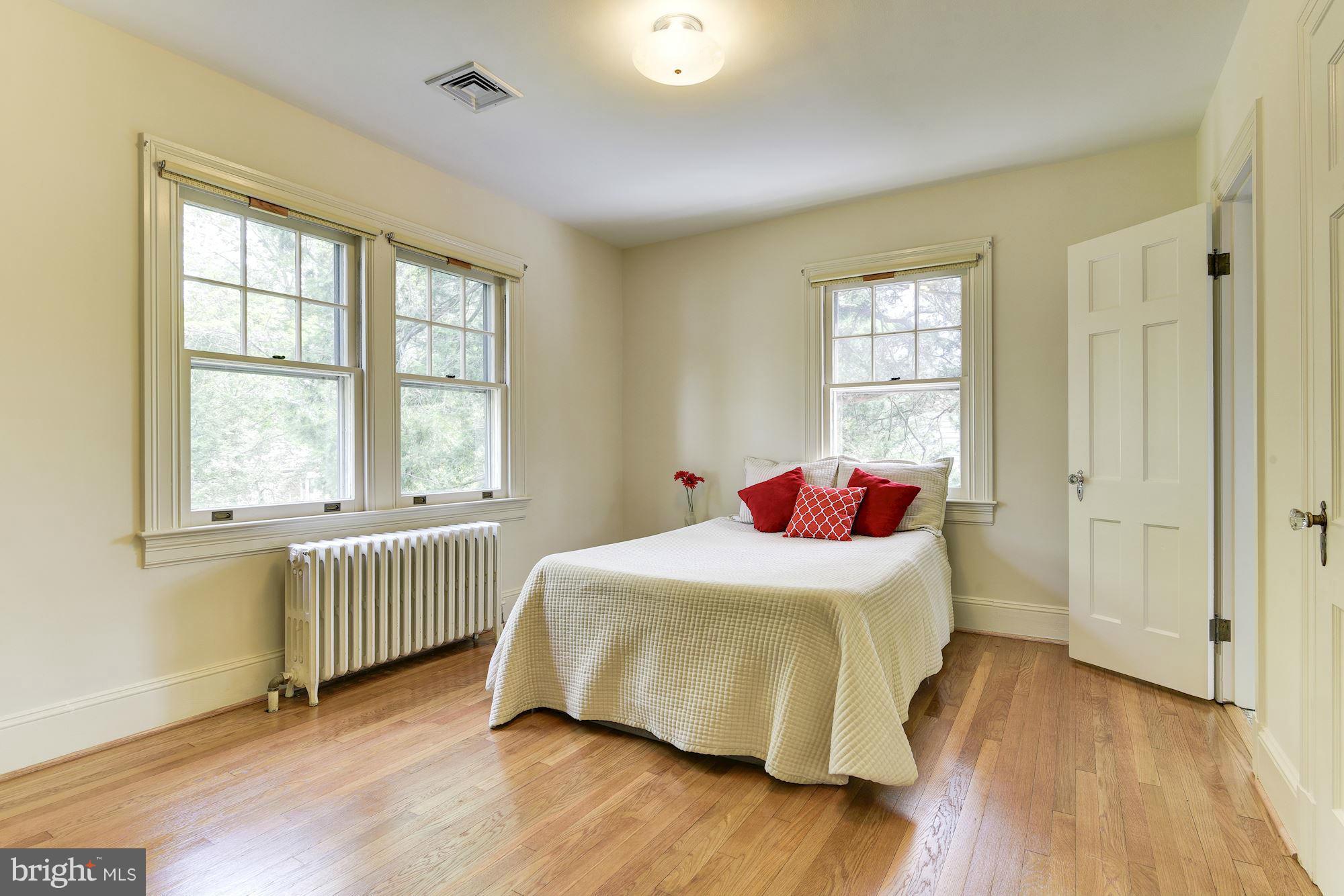 210 Baltimore Road Rockville, MD 20850 - Photo 13 of 30 a bedroom with a bed and wooden floor