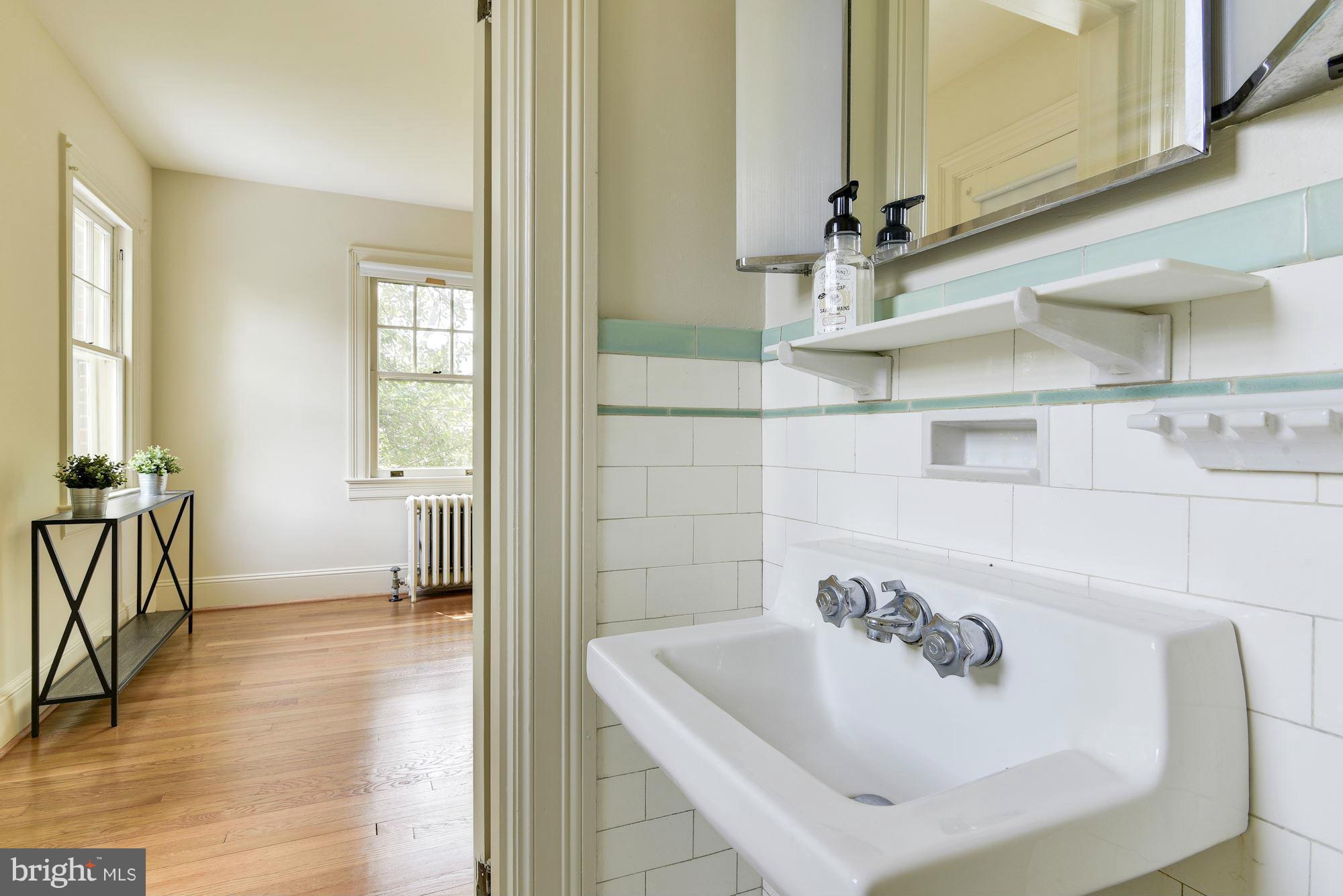 210 Baltimore Road Rockville, MD 20850 - Photo 14 of 30 a bathroom with a sink and a mirror