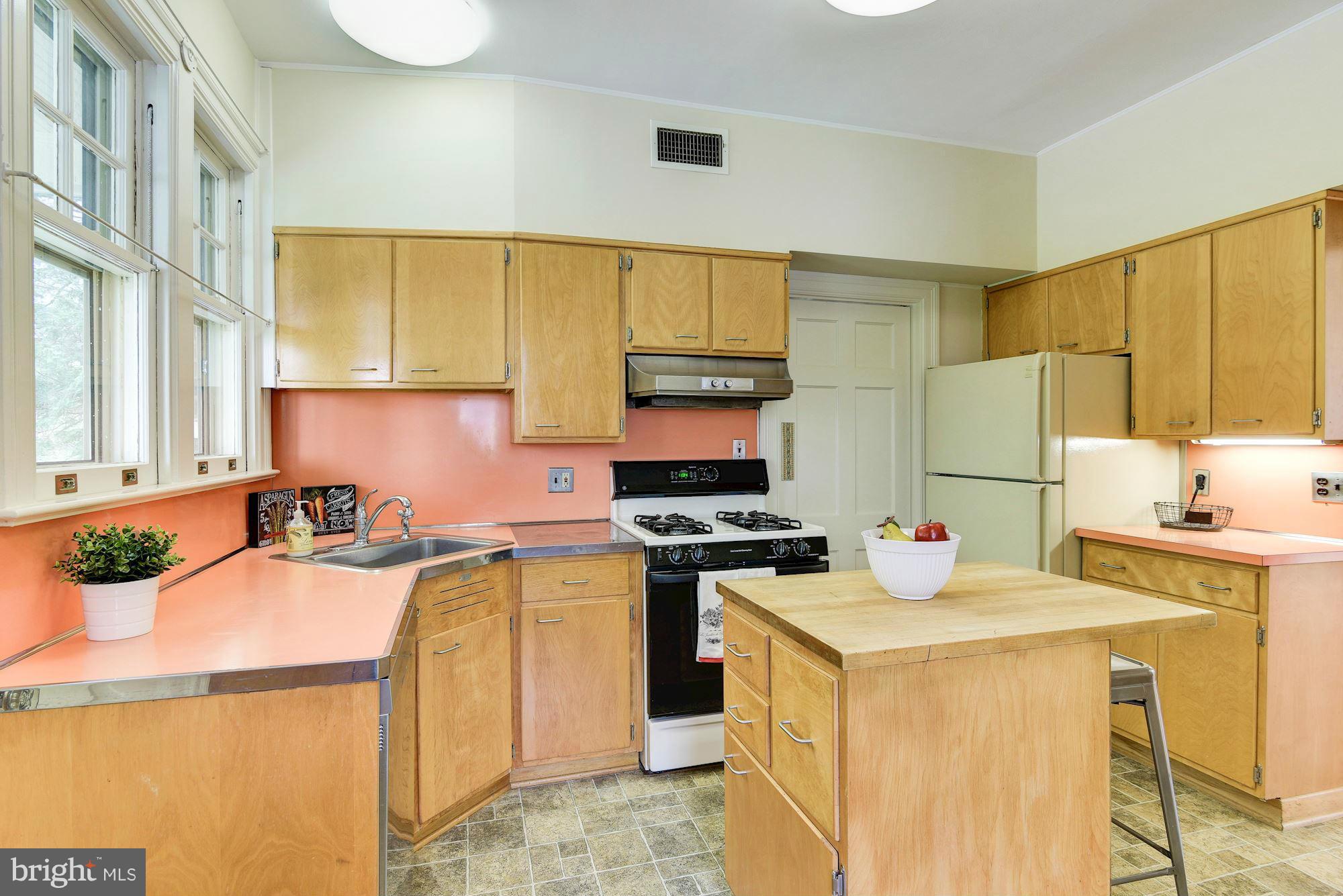 210 Baltimore Road Rockville, MD 20850 - Photo 10 of 30 a kitchen with a stove a sink a refrigerator a counter top space and cabinets