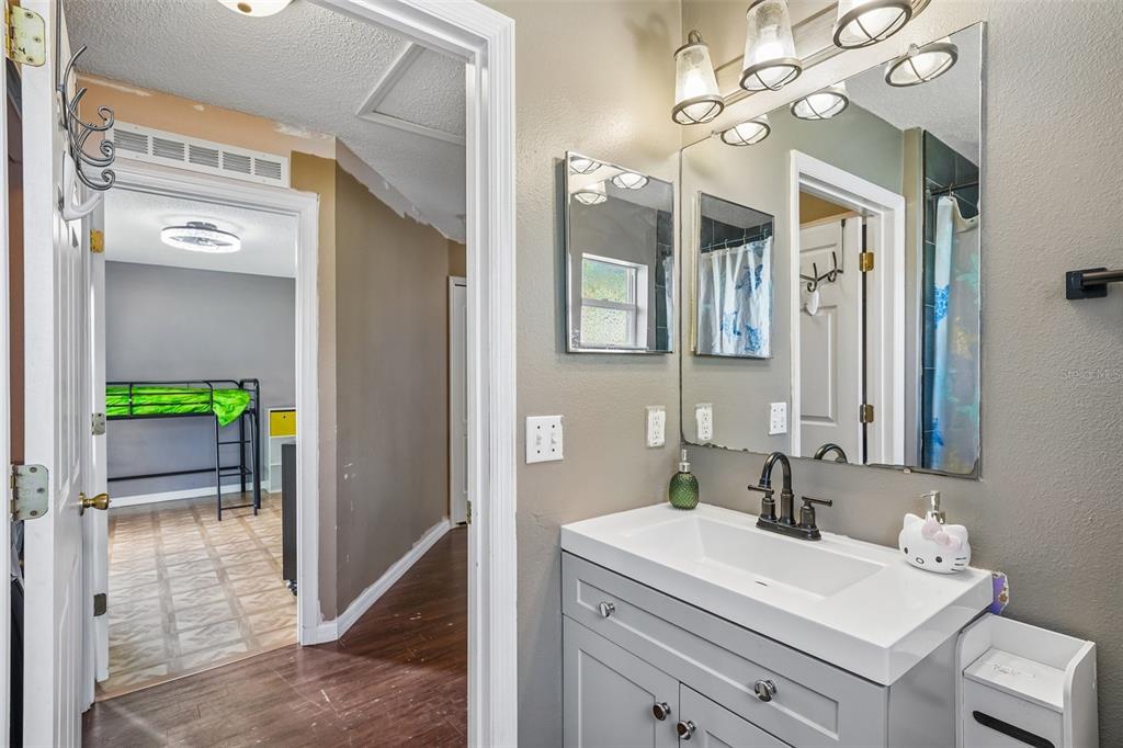 10303 Fordham Street Spring Hill, FL 34608 - Photo 17 of 25 a bathroom with a sink vanity and a mirror